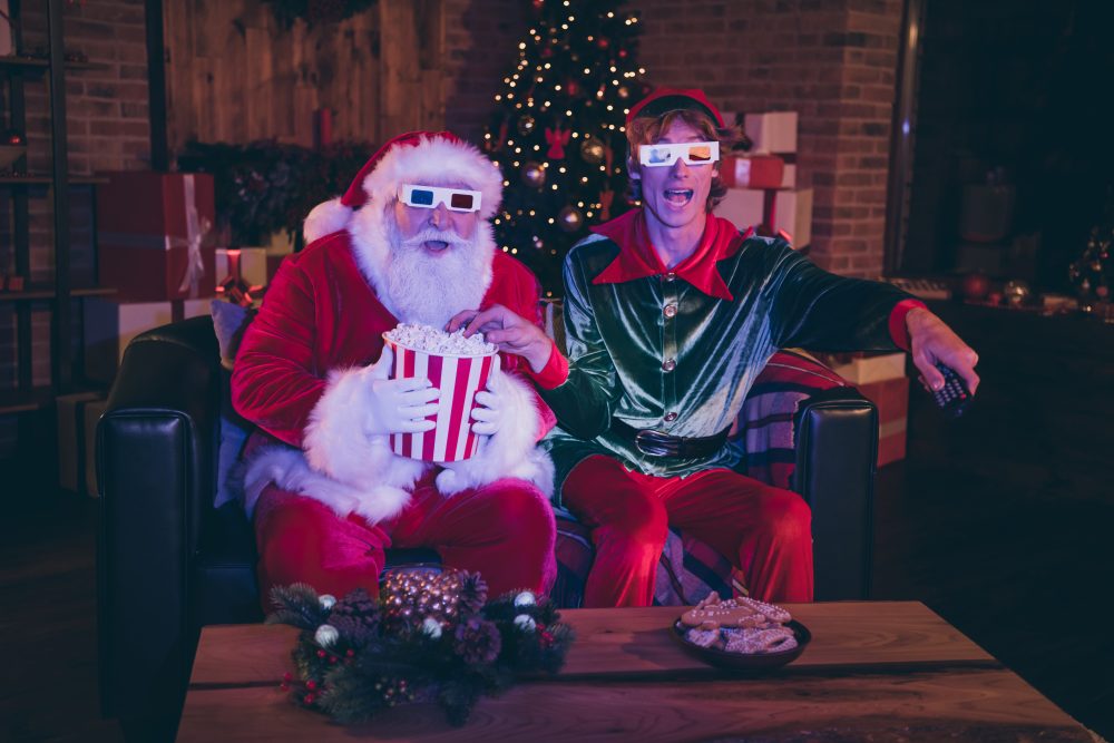 Santa Claus and elf eating popcorn